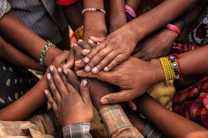 several hands on top one another